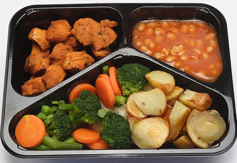 Ready meal in a tray including beans, chicken nuggets