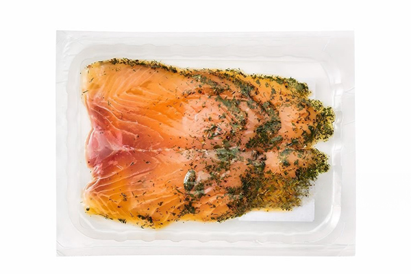 smoked salmon in a plastic tray isolated on white.